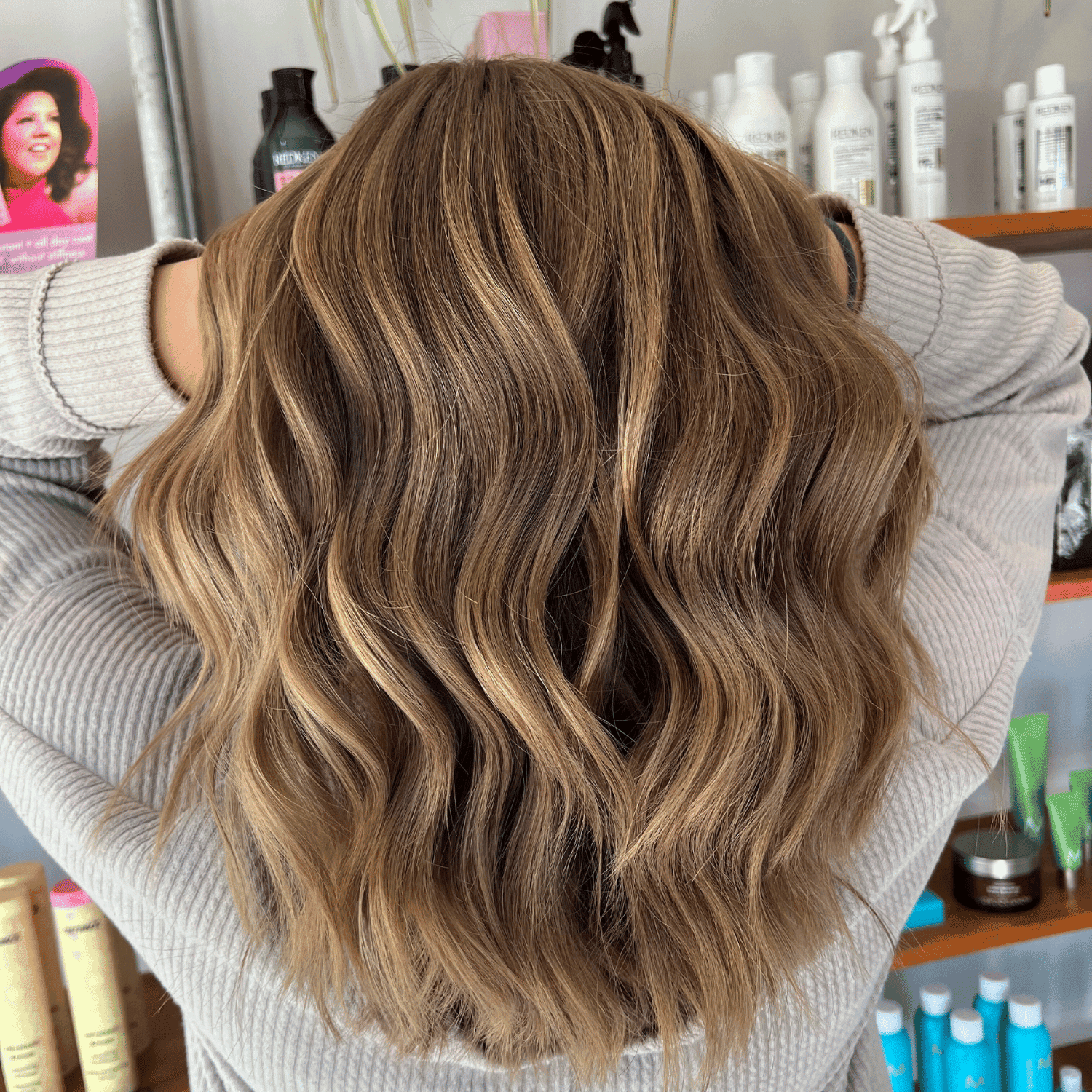 Wavy blonde hair with highlights, styled in a salon.