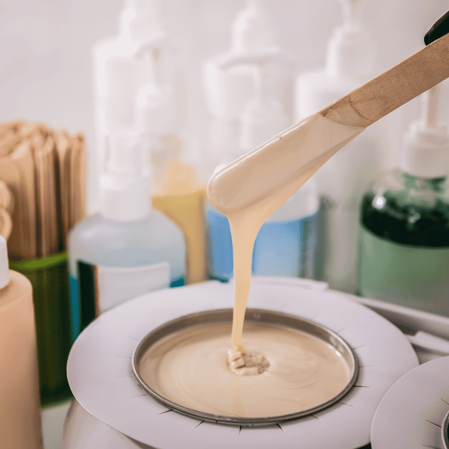 Warm wax being prepared for application at a beauty salon.